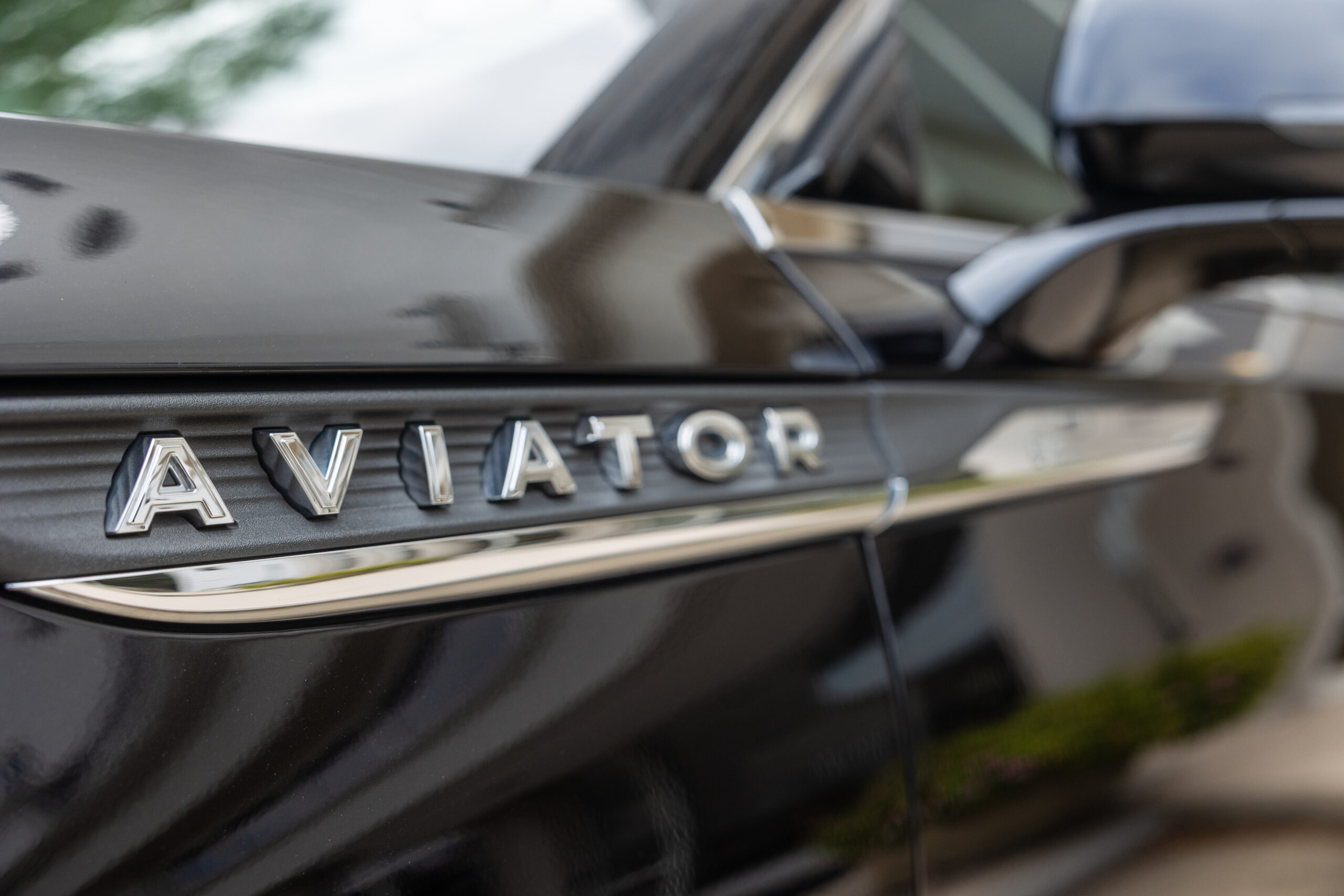 A close-up of the Aviator logo on a luxurious vehicle.