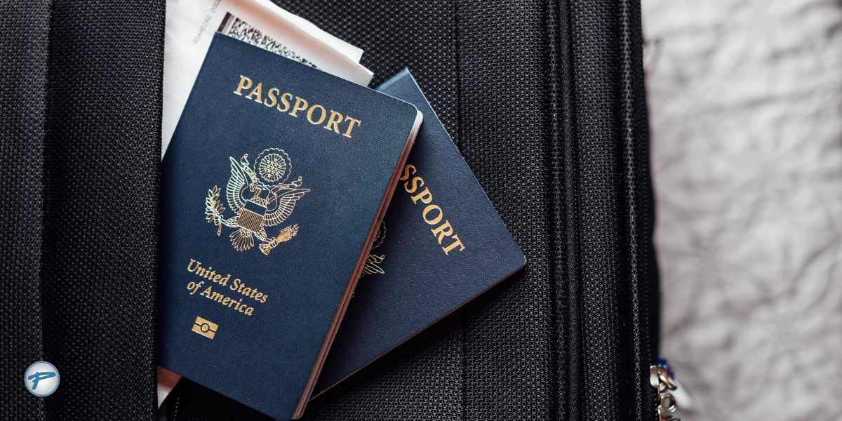 Close-up of U.S. passports and travel documents on a suitcase, symbolizing international travel readiness and Peak Limo’s trusted global travel service.