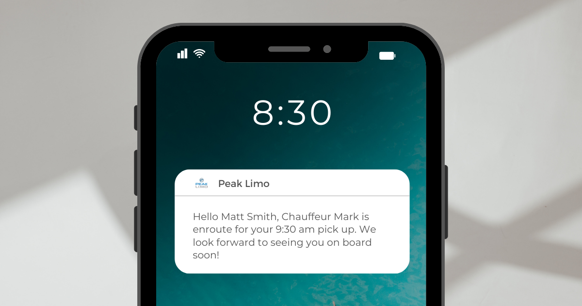 Smartphone screen displaying a notification from Peak Limo about an upcoming pickup, highlighting airport transfer service with real-time communication